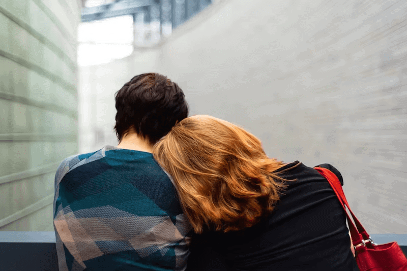 Two people comfort each other with an embrace